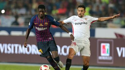 Barcelona's Ousmane Dembele vies for the ball with Sevilla's Jesus Navas. AP Photo