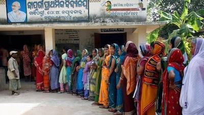 Voters line-up to cast their votes at a polling station in Mahanadi Vihar.