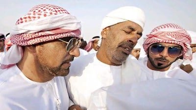 Members of the Emirati family killed in a car crash in Oman mourn at the Al Foah Graveyard in Al Ain. Jeff Topping / The National