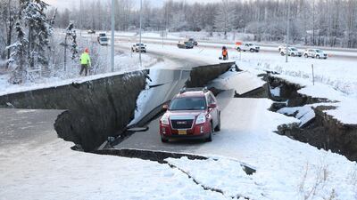 A vehicle lies stranded on a collapsed roadway near the airport after an earthquake in Anchorage, Alaska. Reuters