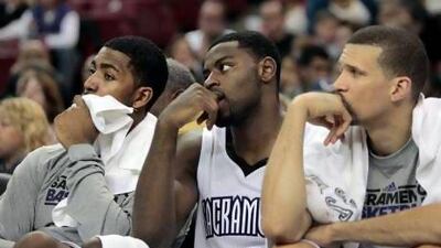 Sacramento Kings players, from left, Jason Thompson, Tyreke Evans and Francisco Garcia watch during the closing moments of their NBA basketball game against the Miami Heat in Sacramento, Calif., Saturday, Jan. 12, 2013. The Heat won 128-99. (AP Photo/Rich Pedroncelli) *** Local Caption *** HeatKings Basketball.JPEG-05fa7.jpg