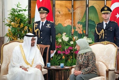 Sheikh Mohamed bin Zayed meets Halimah Yacob, president of Singapore, during his official visit to the country. Courtesy Sheikh Mohamed bin Zayed Twitter