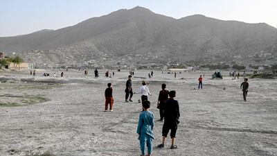 Children play football on a dried-up lake bed in Kabul.