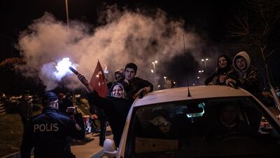 Supporters of Justice and Development Party (AK Party) hold Turkish flags as they celebrate early results for Istanbul mayor in local elections in Istanbul. EPA