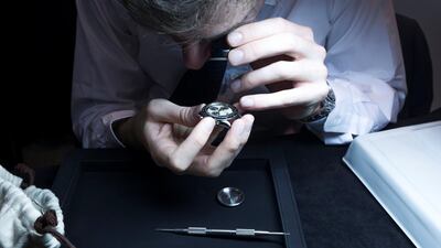 A watch expert checking the authenticity of a watch at the Christie's auction at Emirates Tower Hotel, Dubai. Leslie Pableo / The National