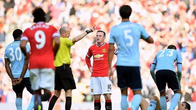Wayne Rooney of Manchester United receives a straight red card by referee Lee Mason after a foul on Stewart Downing of West Ham during United's 2-1 win on Saturday at Old Trafford. Laurence Griffiths / Getty Images