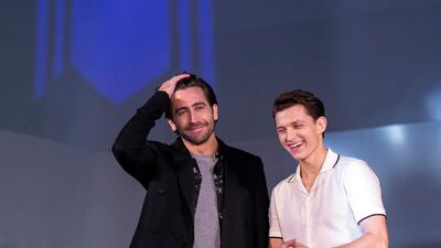Jake Gyllenhaal and Tom Holland, in a white bowling shirt and grey trousers, attend a 'Spider-Man: Far From Home' fan event in Seoul on June 30, 2019. Getty Images