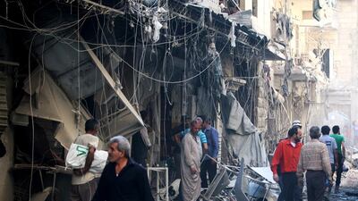 Civil defence members and men inspect a site damaged after an air strike on the besieged rebel-held Al Qaterji neighbourhood of Aleppo on October 11, 2016. Abdalrhman Ismail/Reuters