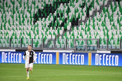 Juventus forward Cristiano Ronaldo runs on the pitch in an empty stadium due to the novel coronavirus outbreak. All matches have now been called of until April 3 at the earliest. AFP