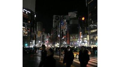 City lights and billboards are turned off in Tokyo's Shibuya fashion and nightlife district. The Japanese government credits individuals' power-saving tactics for allowing a temporary halt to planned blackouts in the capital.