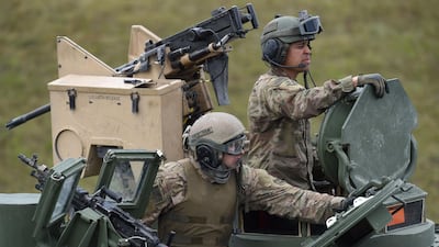 In this file photo taken on May 12, 2017, US soldiers sit in a tank type 'M1A2 SEP' during the exercise 'Strong Europe Tank Challenge 2017' at the exercise area in Grafenwoehr, Germany. AFP