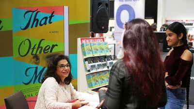 Emirati Maha Gargash signing copies of her latest novel, That Other Me, at a local bookstore. Pawan Singh / The National