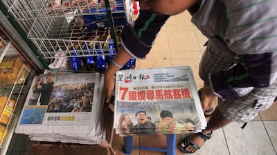 A vendor prepares newspapers leading with Saturday’s missing Malaysian Airlines plane, in Shah Alam, outside Kuala Lumpur, Malaysia. An international fleet of planes and ships scouted the waters between Malaysia and Vietnam for any clues to the fate of the Malaysian Airlines Boeing 777, which disappeared less than an hour after taking off from Kuala Lumpur bound for Beijing. Lai Seng Sin / AP Photo