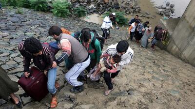 A group of people being evacuated from flood-affected areas in Lasjan area on the outskirts of Srinagar, the summer capital of Indian Kashmir. Farooq Khan/EPA