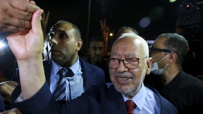 Rached Ghannouchi, head of Tunisia's Islamist Ennahda party, greets his supporters as he leaves the office of Tunisia's counter-terrorism prosecutor in Tunis on July 19, 2022. AFP