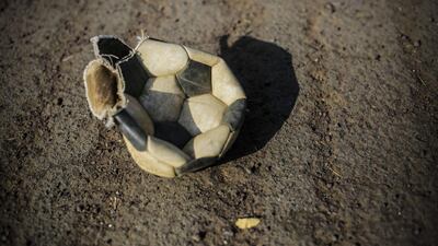 A worn-out football ball is pictured in a field at the Don Bosco Youth Centre in Managua, on January 17, 2016. Football is gaining enthusiasts in Nicaragua where baseball has been historically dominant but is now giving way to the new sport, analysts said. Inti Ocon / AFP