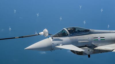 Offshore wind turbines dot the seascape as an RAF Typhoon fighter jet is refuelled while flying over the North Sea. Getty Images