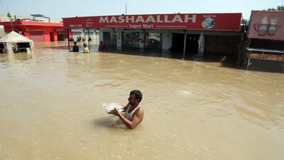 A man wades through floodwater to receive aid n Pakistan's Punjab province. More than two million people have fled the floods in the area. EPA