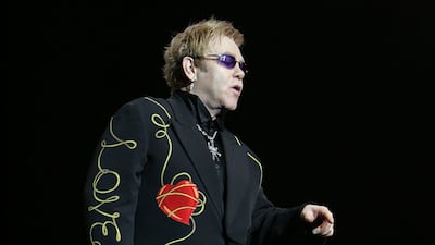 Elton John, in a black suit with a 'love' print, performs in Sydney, Australia on May 12, 2008. Getty Images