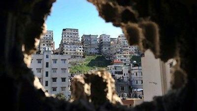 Lebanon's tourism minister wants 4 million tourists a year to visit the country by 2015, up from 1 million at present. Above, The Jabal Mohsen neigbourhood appears through a hole in a wall caused by a rocket-propelled grenade. Dimitar Dilkoff / AF