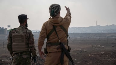 Syrian soldiers look towards Sheikh Maqsoud in Aleppo. Anagha Nair for The National