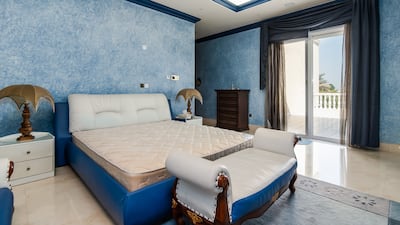 A bedroom with a balcony looking out over the garden. Photo: Engel and Voelkers