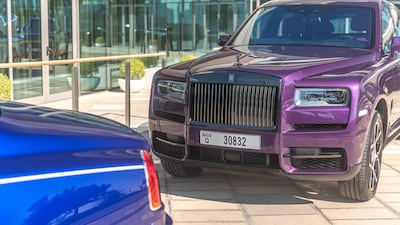 A Cullinan parked behind a Black Badge sibling.