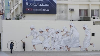 The historic street, formerly known as Al Diyafah Street but renamed in honour of National Day, is the latest area to take part in the project that will eventually see work from local and international artists displayed across the city as well as in the mountain town of Hatta. Jeffrey E Biteng / The National