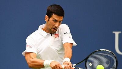 Novak Djokovic returns a shot to Mikhail Youzhny during their third-round match on Friday. Alex Goodlett / Getty Images
