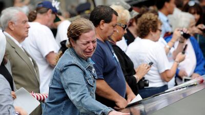 A woman cries while looking at the names inscribed at the North Pool of the 9/11 Memorial during tenth anniversary ceremonies at the site of the World Trade Center September 11, 2011, in New York, USA. EPA/JUSTIN LANE / POOL