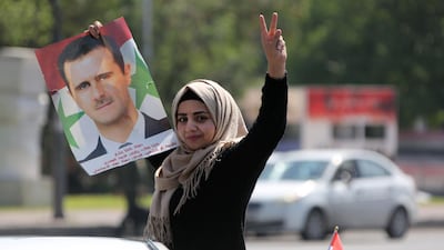 A Syrian woman shows her support for President Bashar al-Assad. AFP Photo