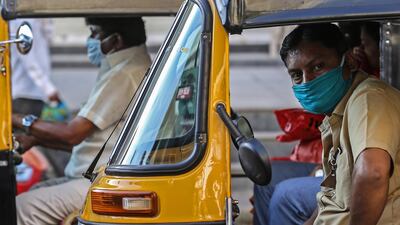 Autorickshaw drivers cover their faces as a precaution against the ongoing pandemic of the Covid-19 disease, in Mumbai, India. EPA
