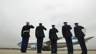 Military personnel salute as Air Force One, with President Barack Obama aboard, leaves Andrews Air Force Base in Maryland, US. Jose Luis Magana / AP Photo