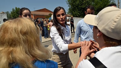 Queen Letizia of Spain visits evacuees from the Madrid wildfire who are sheltered at La Chopera sports centre in Villamanta. AFP