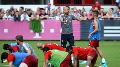 Bayern Munich's coach Pep Guardiola, back centre, gives instructions to Rafinha, right, during their team's training session in Munich, Germany, on July 27, 2015. EPA/ANDREAS GEBERT