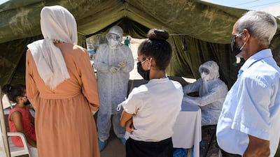 People queue to get tested in the town of El Hamma in Tunisia's south-west Gabes governorate. AFP