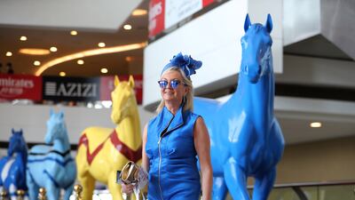 A guest enters Meydan Racecourse before the start of Dubai World Cup. Pawan Singh / The National
