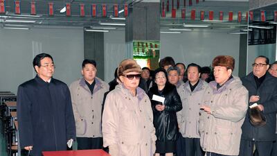 Kim Jong-il (C) and son Jong-un (2nd L) visit commercial centre of Gwangbok District in this picture released by the North's official KCNA news agency in Pyongyang. REUTERS/KCNA