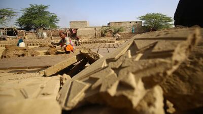 Hilal Bibi, age 90, makes clay pots at a workshop ahead of International Women's Day on the outskirts of Karachi, Pakistan, this week. EPA