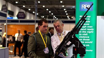 A visitor looks at a machine gun on display at the RPA stand. Ben Pruchnie / Getty Images