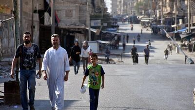 . People walk along a street in Deir Ezzor, Syria in this handout picture provided by th Syrian state news agency SANA on September 11, 2017. SANA/Handout via Reuters