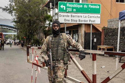A member of the M23 group monitors access to the border post crossing into Rwanda in Goma on January 29. AFP