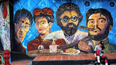 A girl takes off her skates after skating down a street which is closed off to traffic to allow the public to jog, cycle and skate through the Chapinero district of Bogota, Colombia. AFP