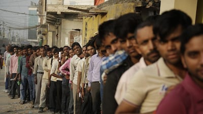 People queue to deposit and exchange discontinued currency notes outside a bank in New Delhi, India, after the government announced the demonetisation of 500 and 1,000-rupee notes to counter corruption. Altaf Qadri / AP Photo