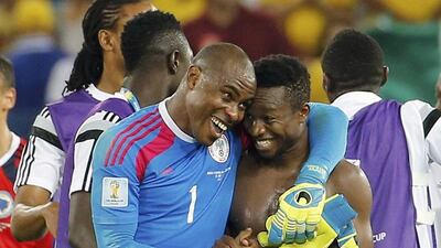 Nigeria's Vincent Enyeama, left, and Ogenyi Onazi, right, embrace after their 1-0 victory over Bosnia on Saturday at the 2014 World Cup in Cuiaba, Brazil. Eric Gaillard / Reuters