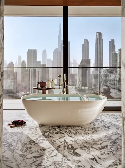 A freestanding bathtub is positioned directly in line with the skyline in the Marina Royal Suite. Photo: Dorchester Collection