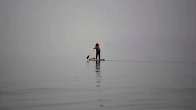 A referee rows her boat out into the middle of the lake for a dragon boat race in Hanoi. Nhac Nguyen / AFP Photo
