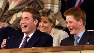 Britain's Prince William and Prince Harry enjoy a concert in the gardens of Buckingham Palace in 2002. Arthur Edwards / AP Photo / Pool