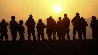 German soldiers and Isaf officers gather during a mission as the sun sets near Kunduz in Afghanistan.
