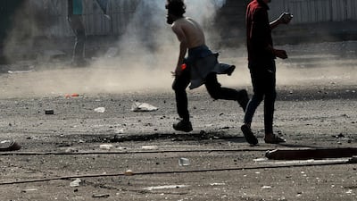 Iraqi security forces fire tear gas during clashes with anti-government protesters, in Baghdad, Iraq. AP Photo